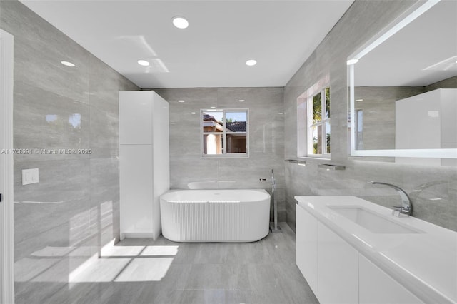 1170 Chenille Cir, Weston, FL 33327 - bathroom with tile walls, a freestanding tub, and vanity