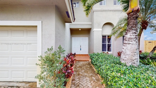 14214 SW 129th Path, Miami, FL 33186 - entrance to property featuring stucco siding, a garage, and fence