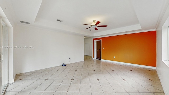 14214 SW 129th Path, Miami, FL 33186 - spare room featuring a tray ceiling, a ceiling fan, ornamental molding, and baseboards