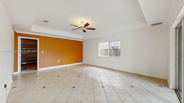 14214 SW 129th Path, Miami, FL 33186 - unfurnished bedroom featuring a tray ceiling, ornamental molding, baseboards, light tile patterned floors, and a ceiling fan