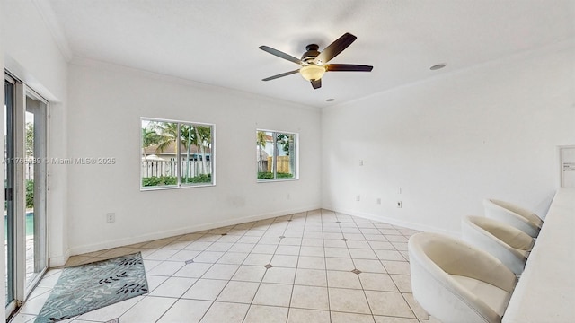 14214 SW 129th Path, Miami, FL 33186 - spare room featuring crown molding, ceiling fan, baseboards, and light tile patterned flooring