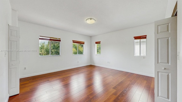 14214 SW 129th Path, Miami, FL 33186 - spare room featuring baseboards and dark wood-style floors
