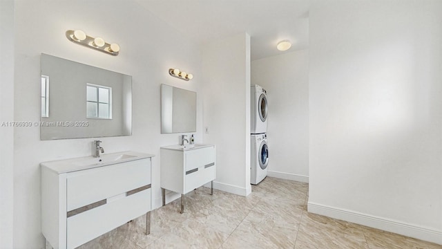 14214 SW 129th Path, Miami, FL 33186 - full bath featuring stacked washer / dryer, two vanities, baseboards, and marble finish floors
