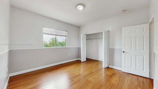 14214 SW 129th Path, Miami, FL 33186 - unfurnished bedroom with light wood-style flooring, a closet, and baseboards