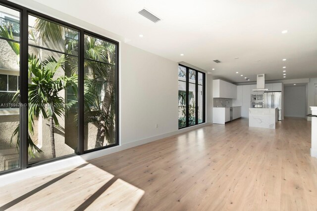 1635 E Broward Blvd, Fort Lauderdale, FL 33301 - unfurnished living room with light wood-type flooring, recessed lighting, and baseboards
