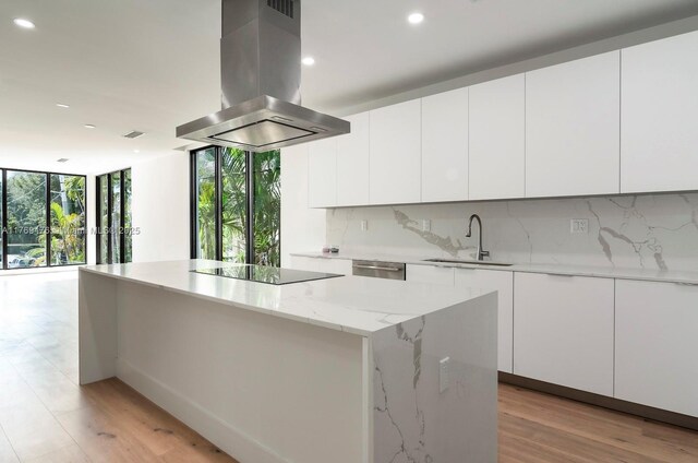 1635 E Broward Blvd, Fort Lauderdale, FL 33301 - kitchen with island range hood, a sink, black electric cooktop, recessed lighting, and a kitchen island