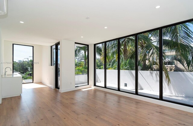 1635 E Broward Blvd, Fort Lauderdale, FL 33301 - unfurnished room featuring light wood-style flooring, recessed lighting, and a sink