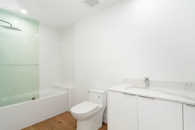1635 E Broward Blvd, Fort Lauderdale, FL 33301 - bathroom with toilet, wood finished floors, vanity, and washtub / shower combination