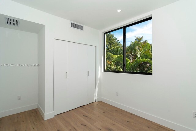 1635 E Broward Blvd, Fort Lauderdale, FL 33301 - unfurnished bedroom featuring baseboards, light wood-style floors, a closet, and recessed lighting