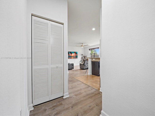 hallway featuring recessed lighting, wood finished floors, and baseboards