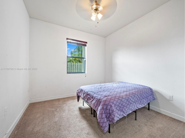bedroom with ceiling fan, baseboards, and carpet floors