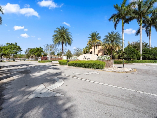 view of street featuring curbs, street lights, and traffic signs