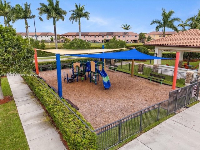 surrounding community with a residential view, playground community, and fence