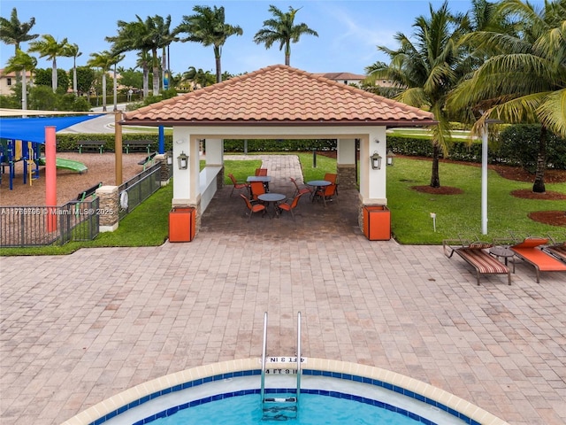 view of pool featuring fence, a gazebo, and a hot tub