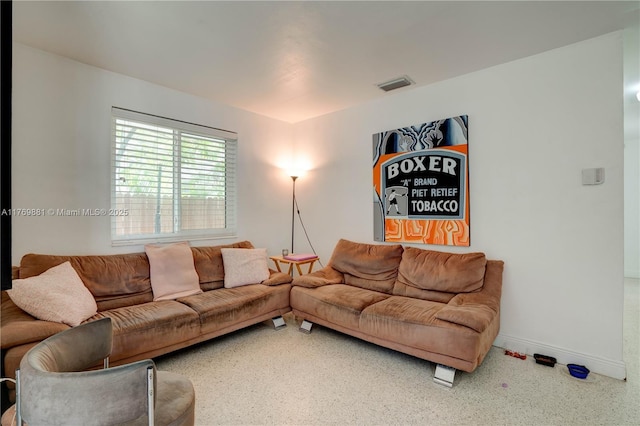 living room with baseboards and visible vents