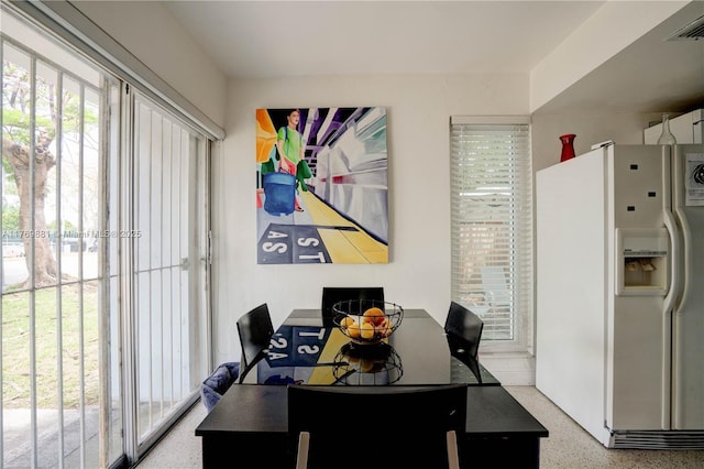 dining room featuring visible vents and speckled floor