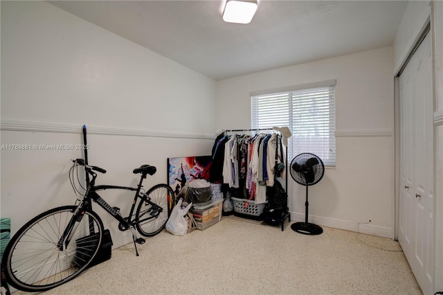 misc room with speckled floor and baseboards
