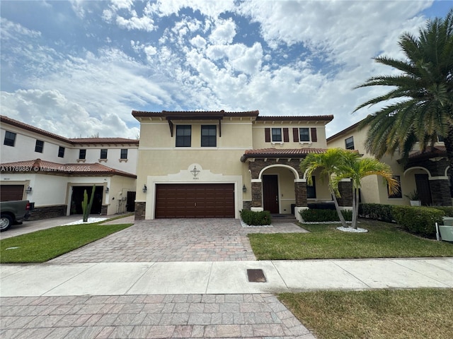 9840 NW 86th Ter, Doral, FL 33178 - mediterranean / spanish-style home with stone siding, decorative driveway, a garage, a tile roof, and stucco siding