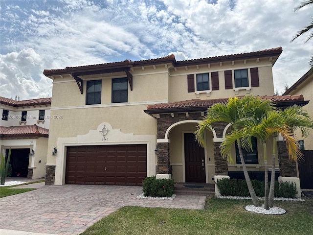 9840 NW 86th Ter, Doral, FL 33178 - mediterranean / spanish home with stucco siding, a tile roof, a garage, and stone siding