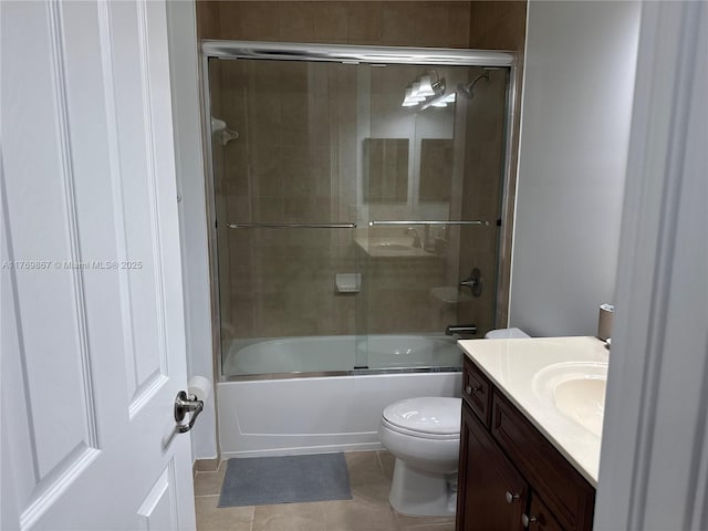 9840 NW 86th Ter, Doral, FL 33178 - bathroom featuring combined bath / shower with glass door, toilet, tile patterned flooring, and vanity