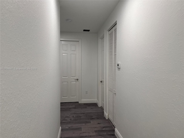 9840 NW 86th Ter, Doral, FL 33178 - corridor with baseboards, visible vents, a textured wall, and wood finished floors