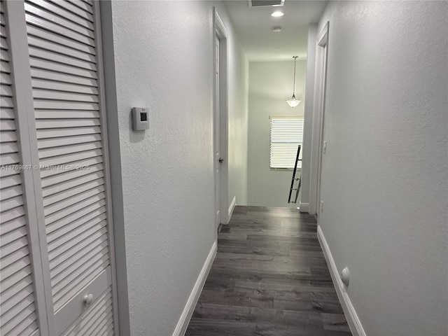 9840 NW 86th Ter, Doral, FL 33178 - hallway with dark wood finished floors, baseboards, visible vents, and a textured wall