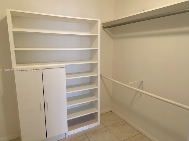 spacious closet featuring light tile patterned flooring