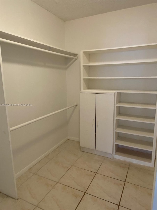 spacious closet with light tile patterned flooring