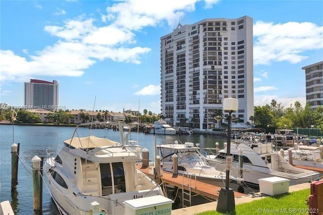 view of dock featuring a water view and a view of city
