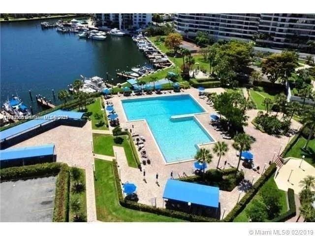 community pool featuring a water view and a patio area