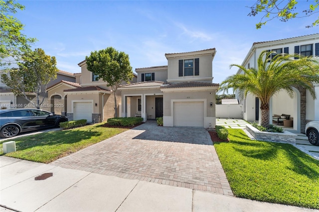 870 NE 191st St, Miami, FL 33179 - view of front of property with a front yard, stucco siding, an attached garage, a tiled roof, and decorative driveway