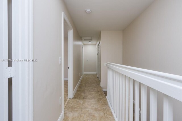 4834 NW 58th Mnr, Coconut Creek, FL 33073 - hallway featuring light tile patterned floors, baseboards, and attic access