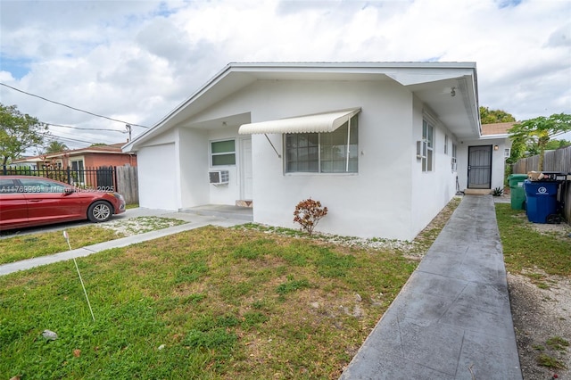 1167 NE 111th St, Miami, FL 33161 - view of front facade featuring a front yard, stucco siding, and fence