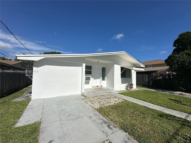 1167 NE 111th St, Miami, FL 33161 - view of front of house with a front yard, stucco siding, and fence