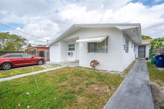 1167 NE 111th St, Miami, FL 33161 - bungalow with stucco siding, fence, and a front lawn