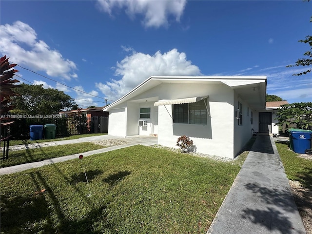 1167 NE 111th St, Miami, FL 33161 - view of front of house featuring stucco siding, fence, and a front lawn