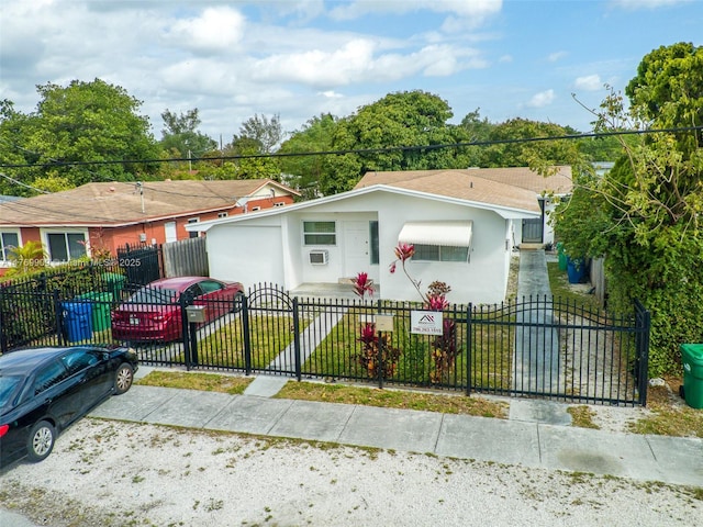 1167 NE 111th St, Miami, FL 33161 - view of front of house with a fenced front yard, a gate, and stucco siding