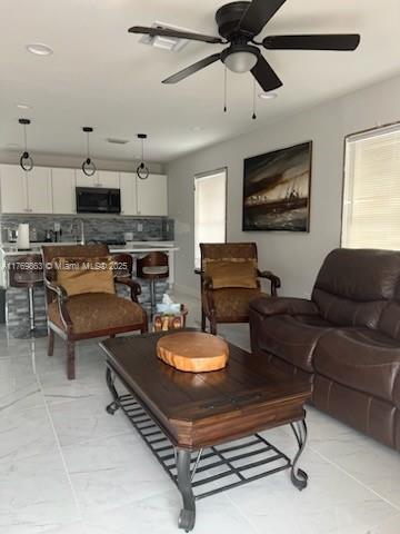 living room with a ceiling fan