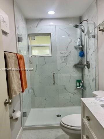 full bathroom featuring a marble finish shower, marble finish floor, toilet, and vanity