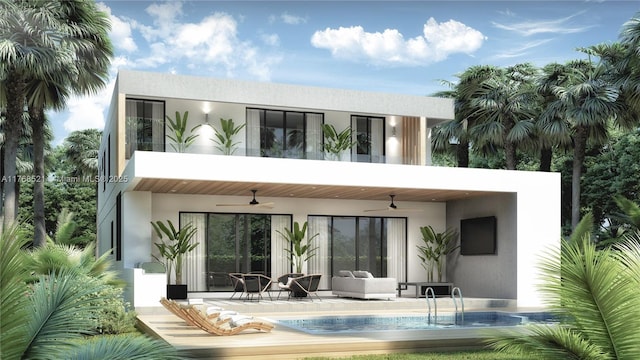 back of house featuring stucco siding, a ceiling fan, a patio, a balcony, and an outdoor pool