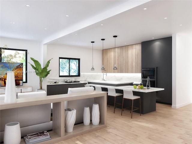 kitchen with light wood-style flooring, light countertops, dobule oven black, modern cabinets, and decorative backsplash