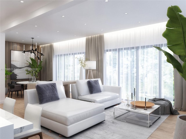 living room featuring recessed lighting, light wood-style floors, and an inviting chandelier