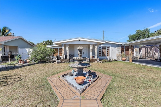 881 Hialeah Dr, Hialeah, FL 33010 - view of front of home featuring a front yard, a carport, and stone siding