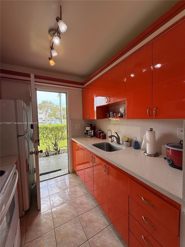 kitchen with light tile patterned flooring, light countertops, a sink, and electric range oven