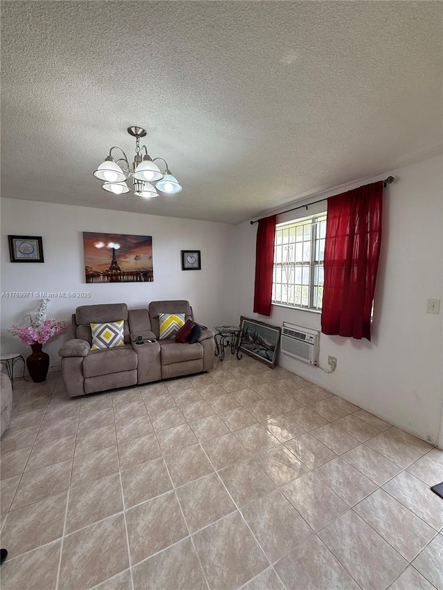 tiled living room featuring a textured ceiling, a wall mounted AC, and an inviting chandelier