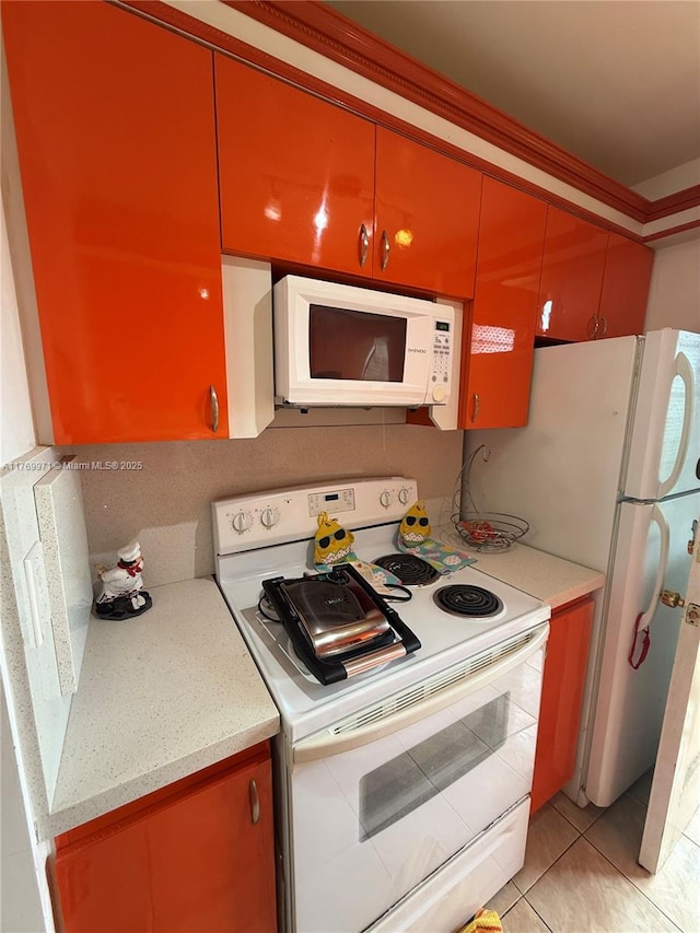 kitchen featuring white appliances and light tile patterned floors