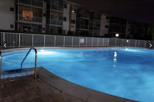 community pool featuring fence