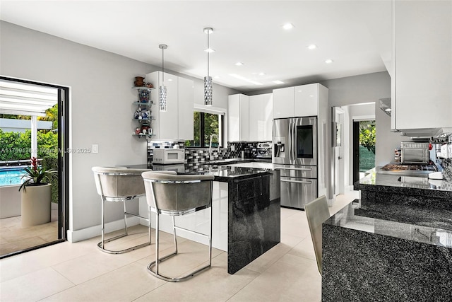 tiled living area featuring recessed lighting, visible vents, and baseboards