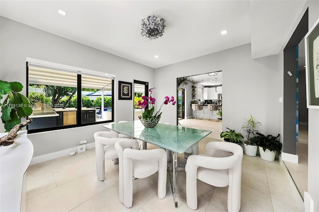 kitchen with tasteful backsplash, double oven range, modern cabinets, and white cabinetry
