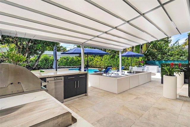 6166 Pine Tree Dr, Miami Beach, FL 33140 - view of patio / terrace with an outdoor kitchen and an outdoor pool